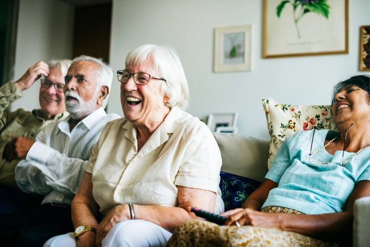 People sitting on a couch laughing