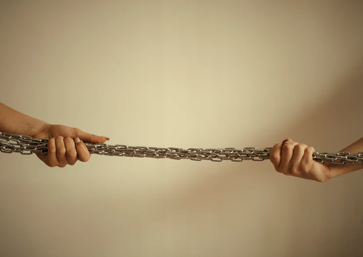 Two people pulling a rope from each side