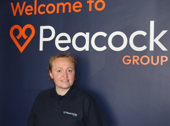 Woman Standing behind Peacocks Branded wall